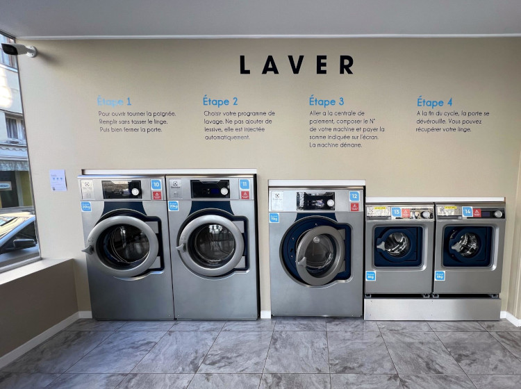 A laundry room featuring multiple washing machines arranged neatly for efficient laundry tasks.